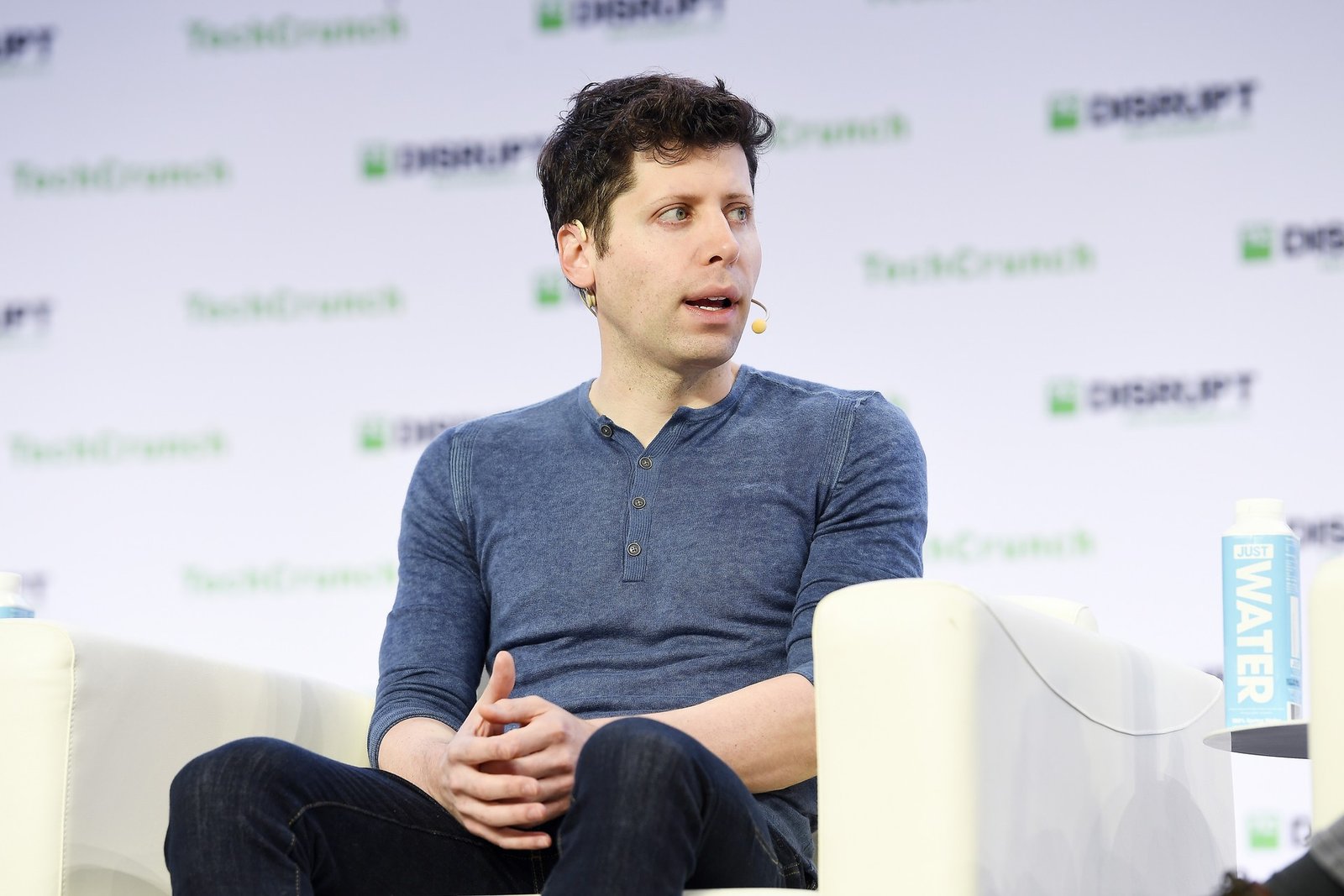 OpenAI CEO Sam Altman speaking on stage at TechCrunch Disrupt
