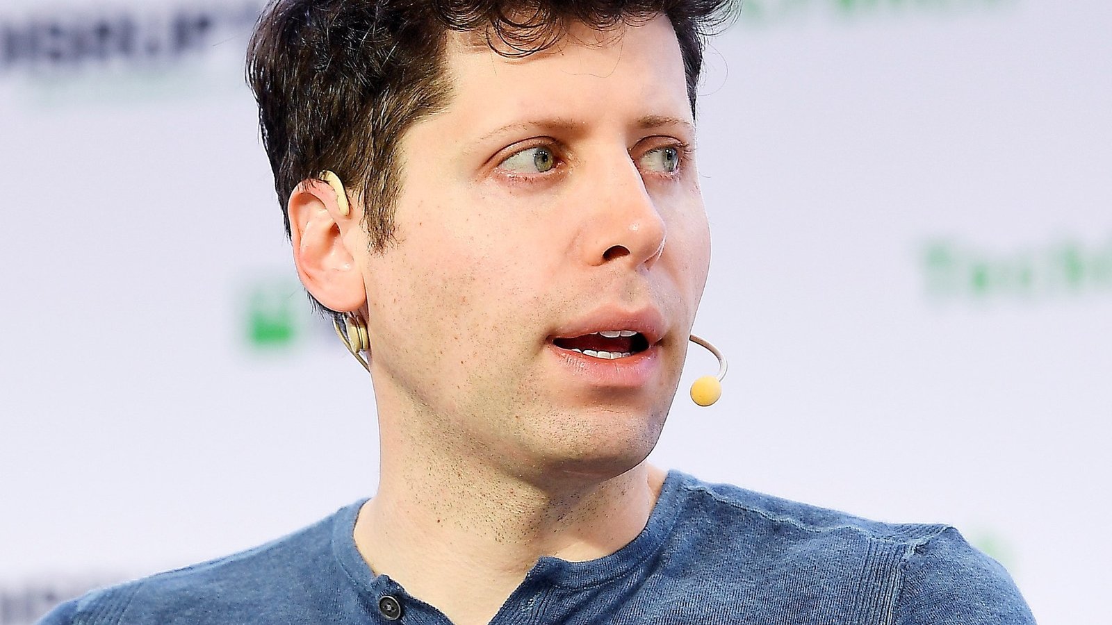 OpenAI CEO Sam Altman speaking on stage