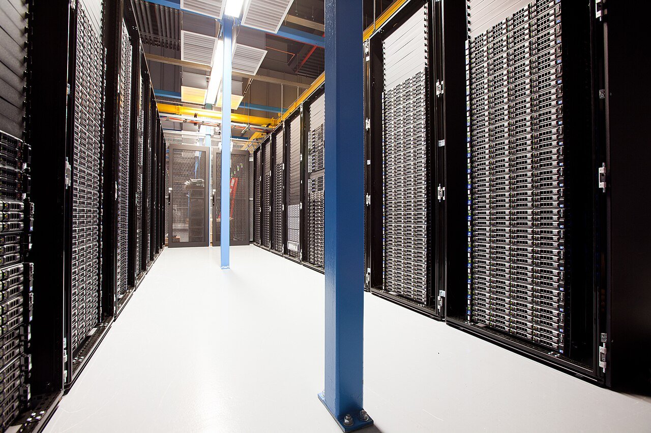 Rows of illuminated server racks in a data center