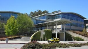 YouTube headquarters building with the YouTube sign visible on the wall under a blue sky
