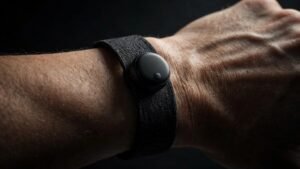 Concept render of a thin fabric fitness band with a small sensor module, evoking Apple's reported screenless Whoop-style tracker