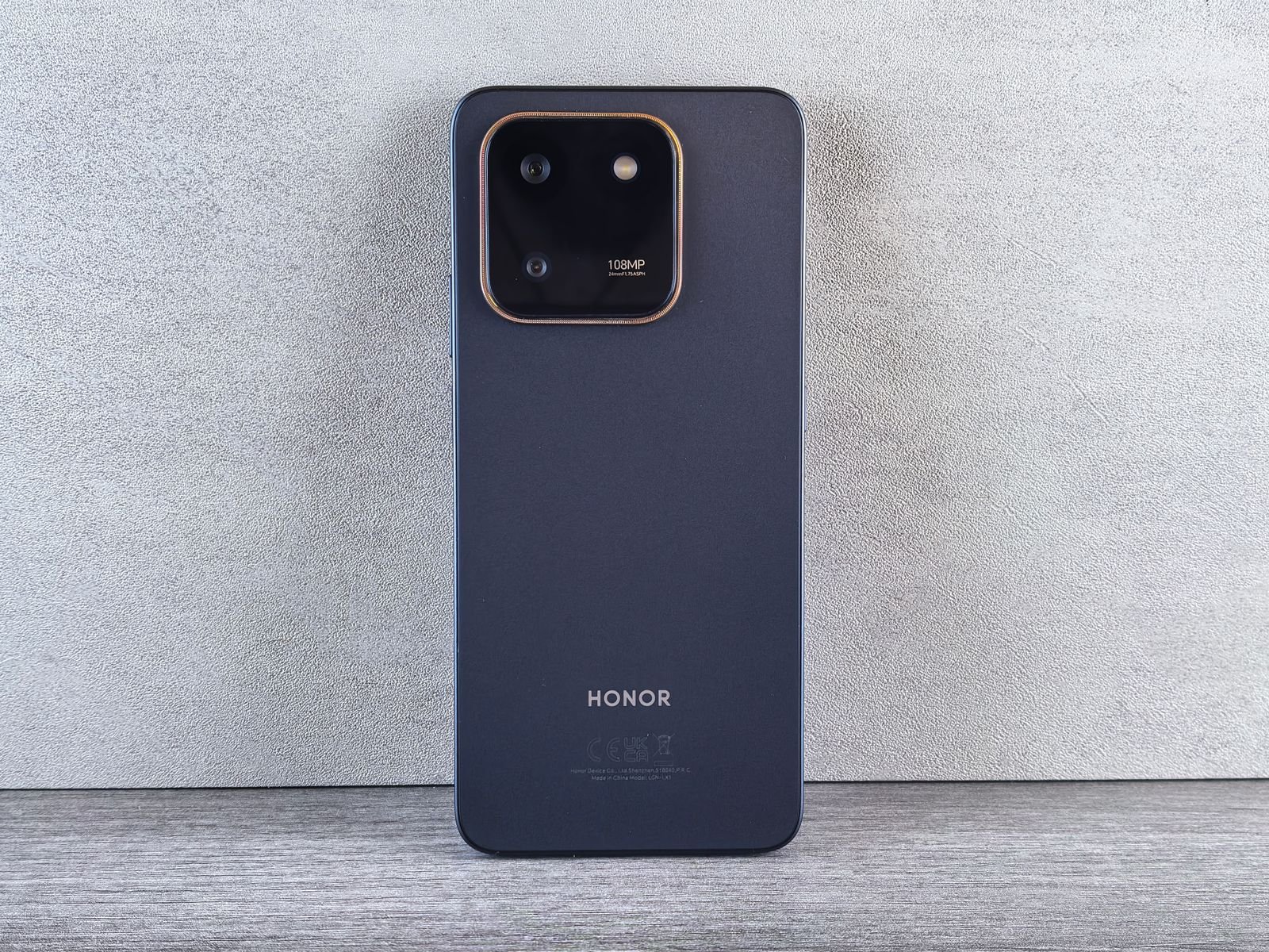Rear view of a black Honor smartphone showing its square camera module