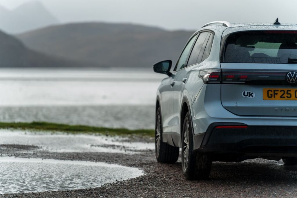 Silver Volkswagen ID.4 parked by a misty mountain lake