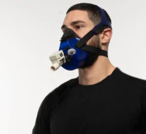 Person wearing a breath-analysis mask during a metabolic fitness test in a gym