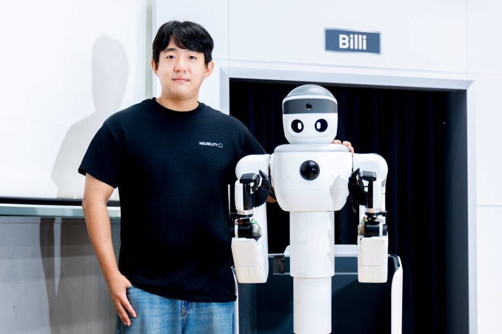 Neubility's Billy semi-humanoid robot with a company engineer