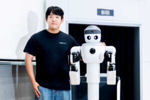 Neubility's Billy semi-humanoid robot with a company engineer