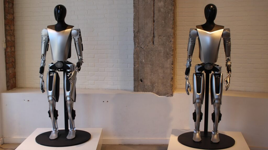 Two Tesla Optimus humanoid robots on display