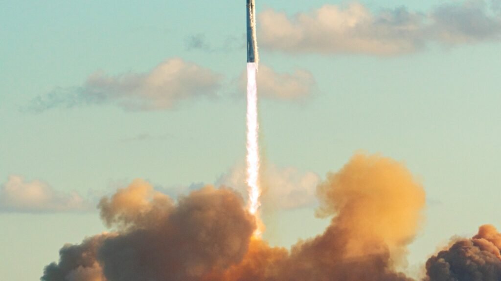 SpaceX Starship lifting off with a bright exhaust plume