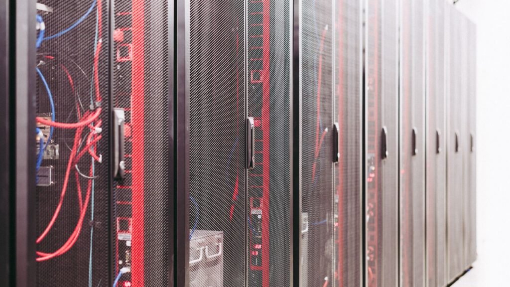 Close-up of server racks with red and blue cabling inside a data center