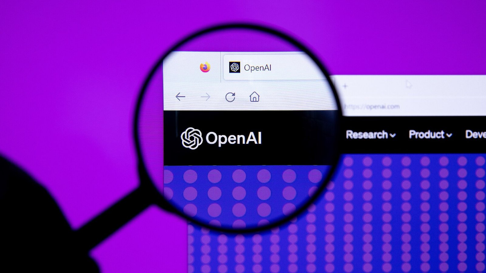 A hand holding a magnifying glass over the OpenAI logo on a computer screen