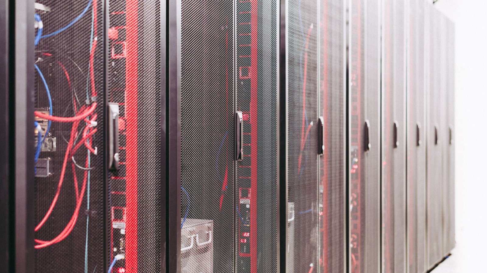 Close-up of server racks with red and blue cabling inside a data center