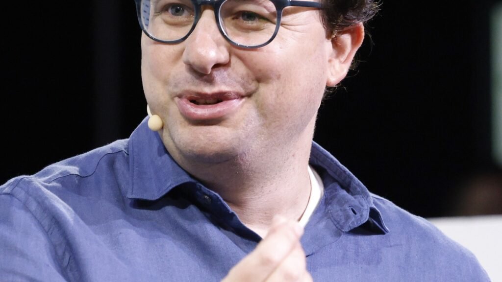 Anthropic CEO Dario Amodei speaking on stage at TechCrunch Disrupt 2023