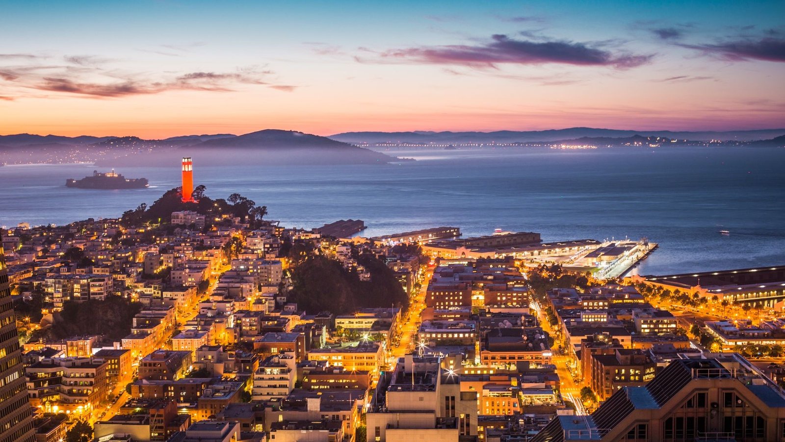 San Francisco skyline and bay glowing at dusk