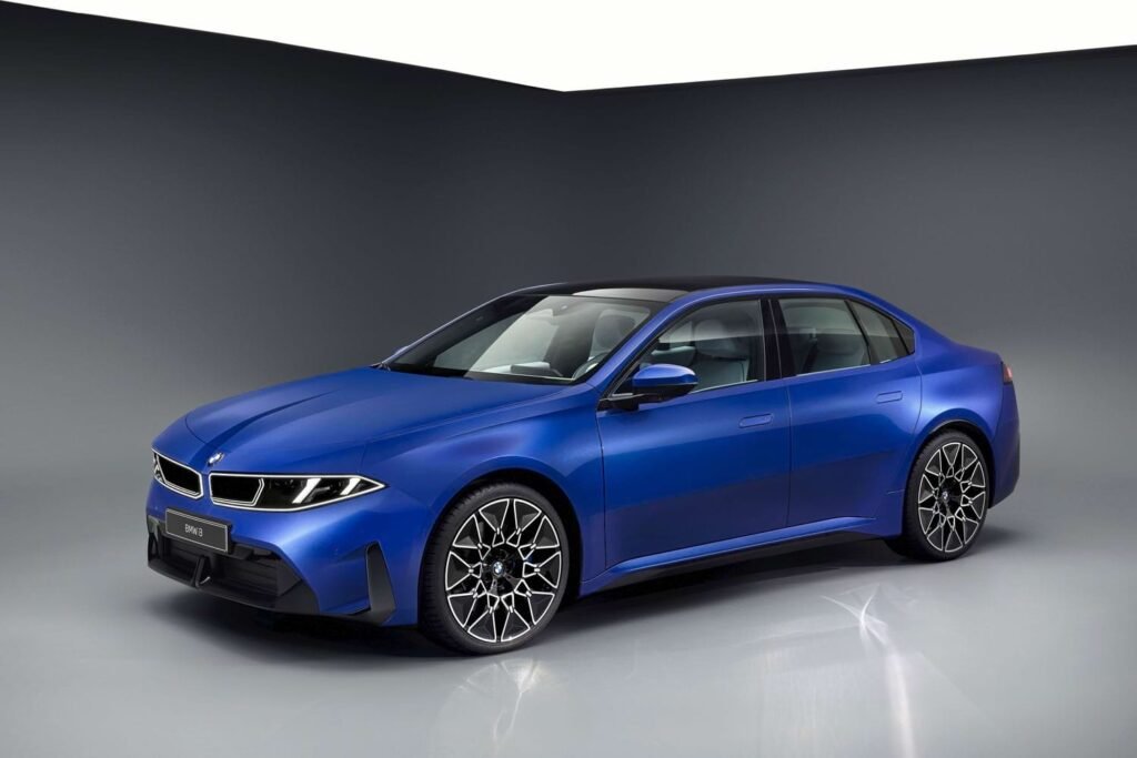 Blue 2027 BMW i3 50 xDrive electric sedan in a studio, front three-quarter view