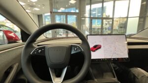 Tesla Model 3 interior with the large center touchscreen switched on
