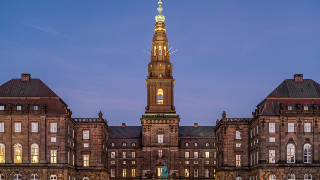 Christiansborg Palace tower illuminated at dusk in Copenhagen, Denmark