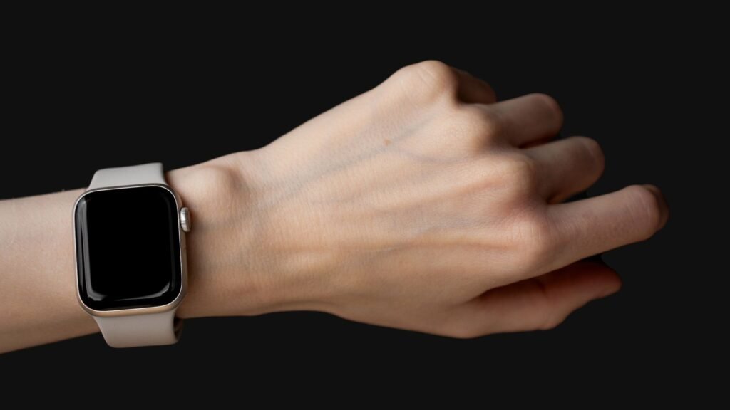 Smartwatch on a wrist against a black background