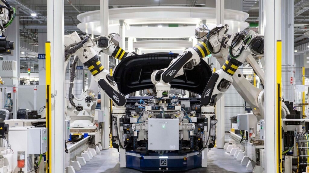 Hyundai WIA robot arms assembling a car body on an automated factory line