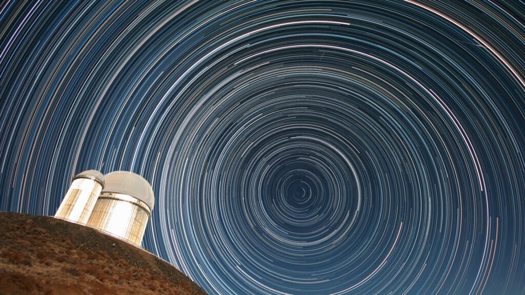 Star trails circling above the ESO 3.6-metre telescope, tracing Earth's rotation in the night sky