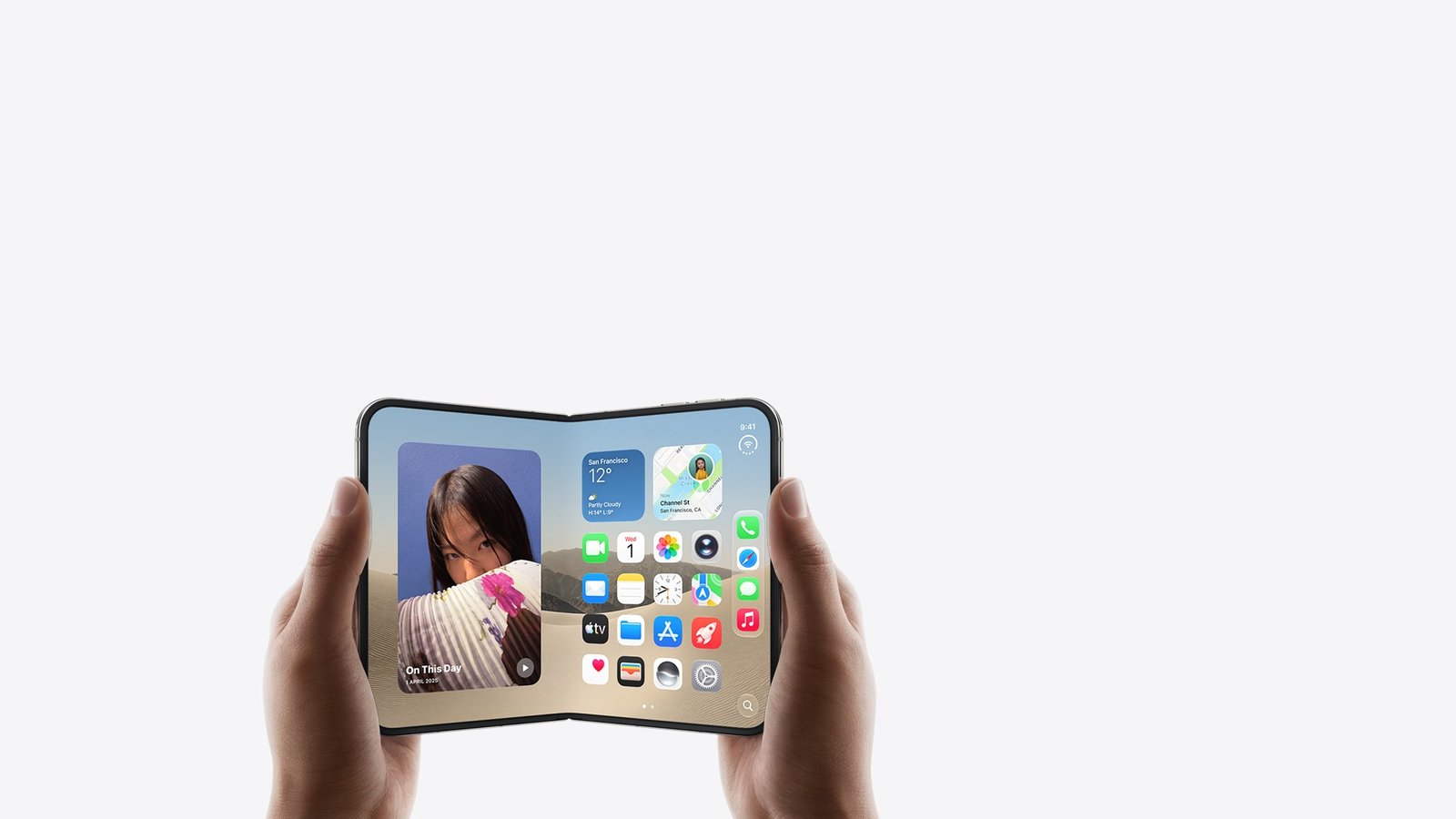 Hands holding the Apple iPhone Duo opened, showing the 7.6-inch inner display