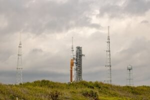 NASA SLS rocket on the launch pad at Kennedy Space Center under a dramatic sky