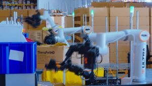 Ultra's dual-arm OP1 warehouse robots packing orders at a fulfillment workstation