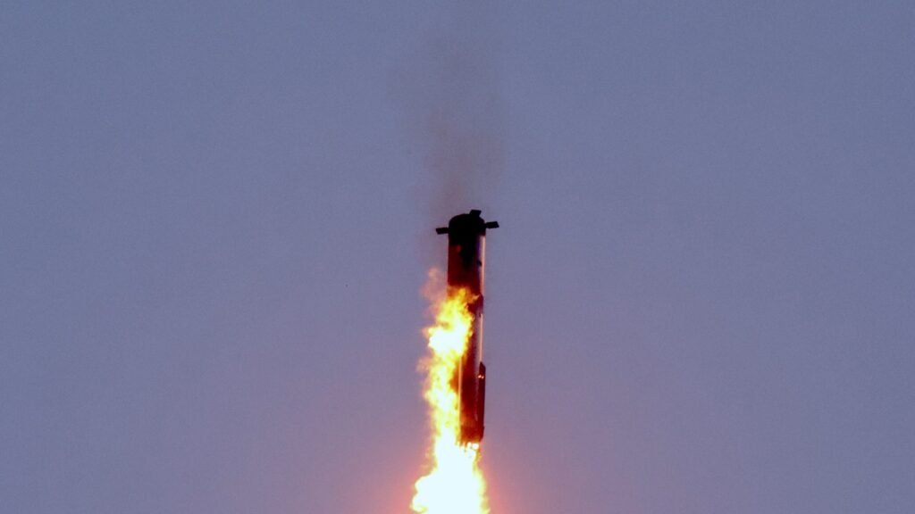 SpaceX Starship upper stage firing its engines during a landing burn beneath a dusk sky
