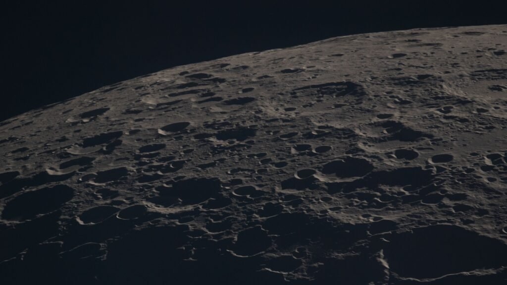 Close-up photograph of the Moon's cratered surface along the terminator line, taken by the Artemis II crew