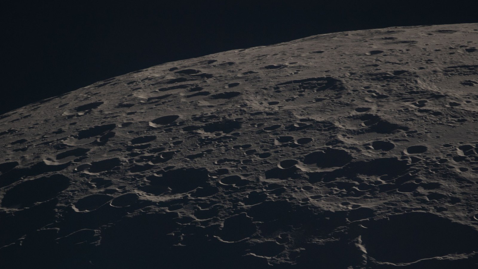 Close-up photograph of the Moon's cratered surface along the terminator line, taken by the Artemis II crew