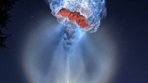 Falcon 9 exhaust plume glowing like a jellyfish in the predawn sky over Cape Canaveral after liftoff