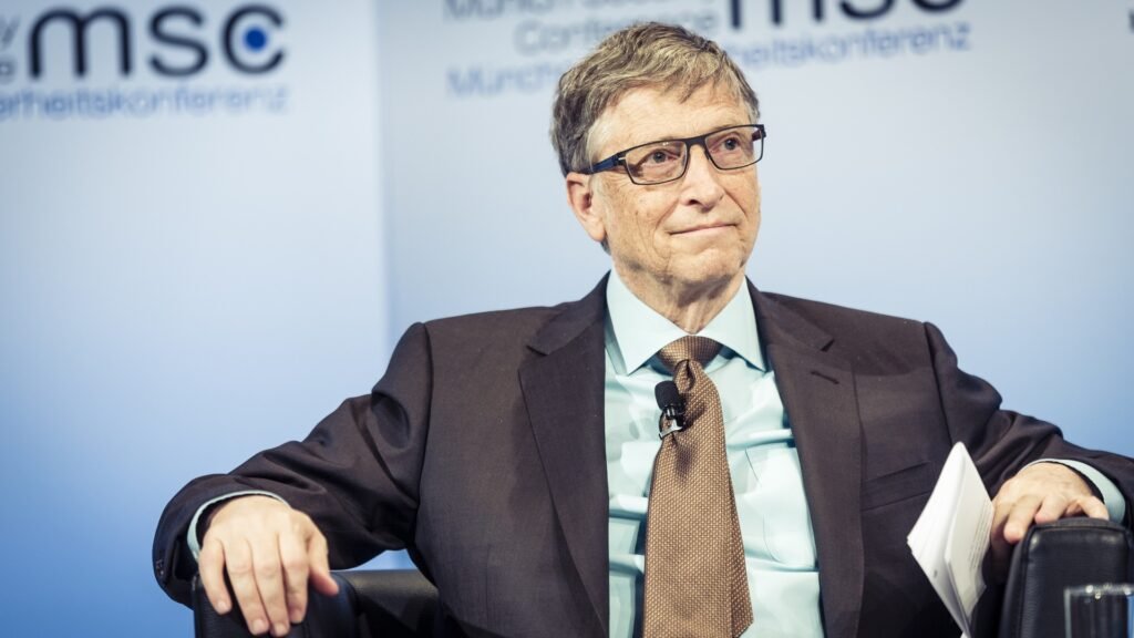 Bill Gates speaking on stage at a conference, portrait photograph